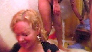 Blonde milf housewife having group sex in a kitchen