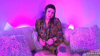 Busty Sammie pleasures herself with a shiny toy on her tatted sofa