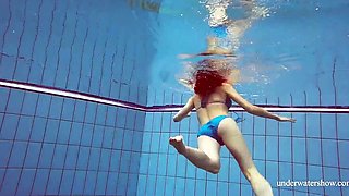 Skinny girl out in the pool cosplaying nirvana album cover underwater