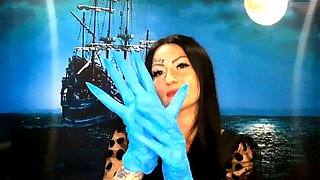 Dominatrix Nika with a glove fetish puts on medical gloves and destroys them with her long tools