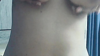 Single girl playing with her huge boobs