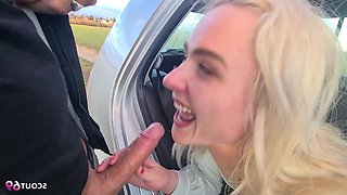 A fair-haired traveler seeking a ride, picked up, engages in an adventurous sexual encounter inside a vehicle in an open area.