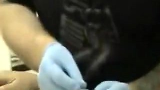 Brunette girl gets her nipples pierced