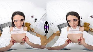 A hot brunette girl is having fun on the bed in vr