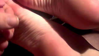 Sexy redhead gets a hot load of cum on her feet and soles in the car after drinks at the bar.