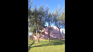 Stepmother in a bikini in the garden of the house makes a video for her stepson, to show off her new clothes.