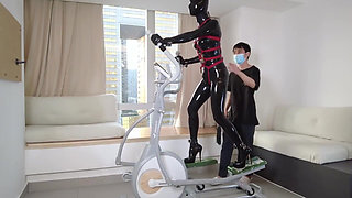 Mz27 - a Girl Bound in Latex Walks on a Treadmill