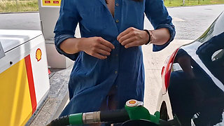 She Is Refueling at the Gas Station, Showing Her Tits and Pussy