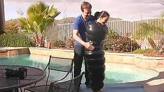 Julia in an inflatable latex cocoon in pool