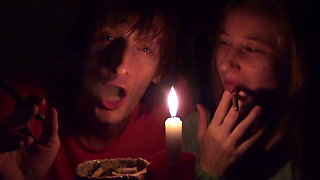 Couple Smoke Next to Candle