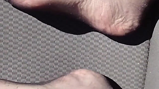 Feet of Nylonjunge in Pantyhose in Car