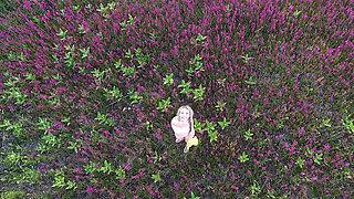 Cutie shows off her body in a flower field