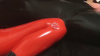 Hot MILF in a Red Latex Catsuit She Is Enjoying It with a Locked Slave. Second Angle