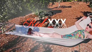 Red XXX stuffs her pussy with a toy in the hammock