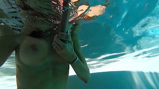 Diving in the pool and playing with a big dildo in HD