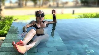 Inked busty femdom MILF vixen posing in black bikini