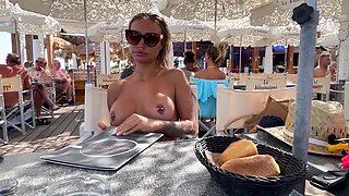 Bodacious babe flaunting big tits and shaved pussy in public