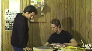 In a kitchen a sexy brunette playing with her big boobs