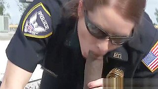 Redhead cop sucks a big black cock