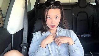 Beautiful Asian girl drives herself to climax in the car